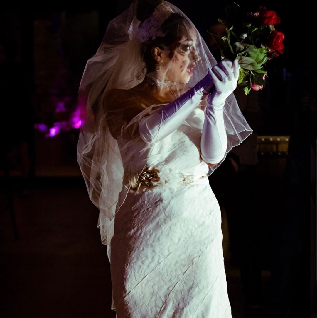 Woman in wedding dress holding roses