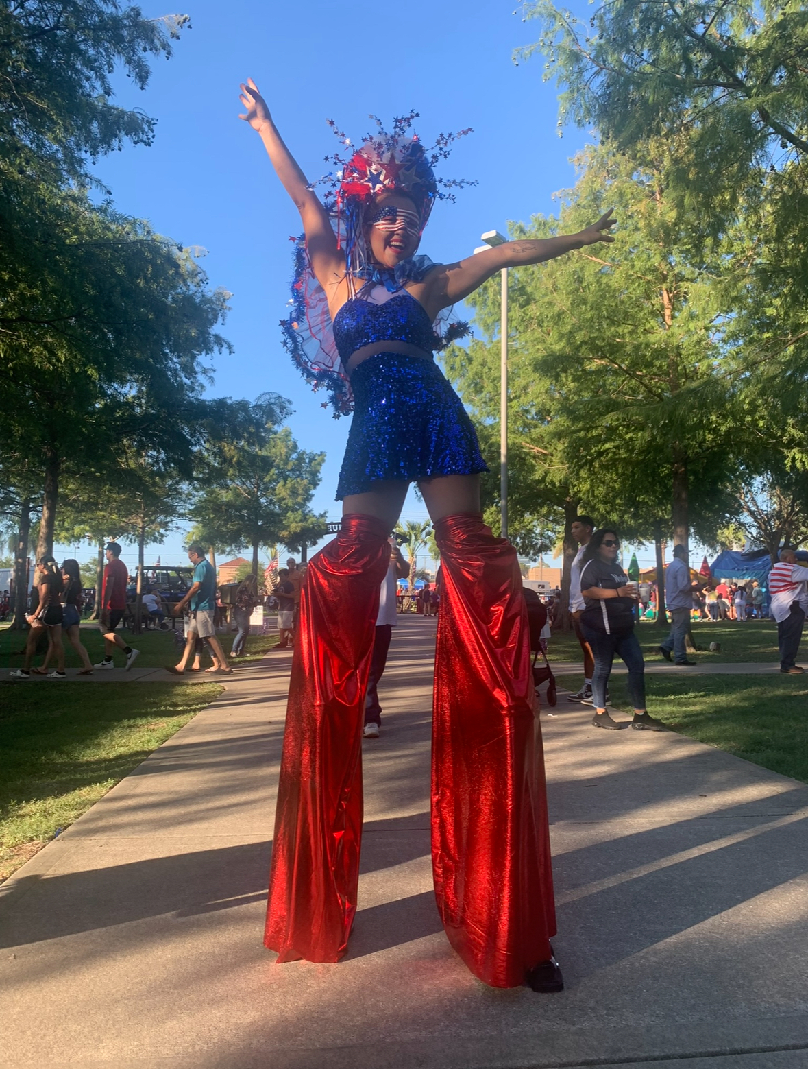 A stilt walker in 4th of July regalia