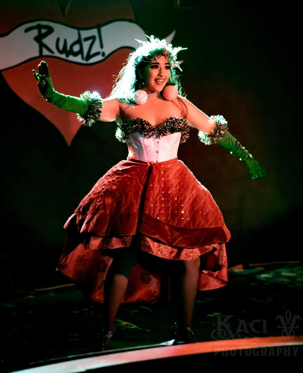 A woman performing in Christmas inspired clothing