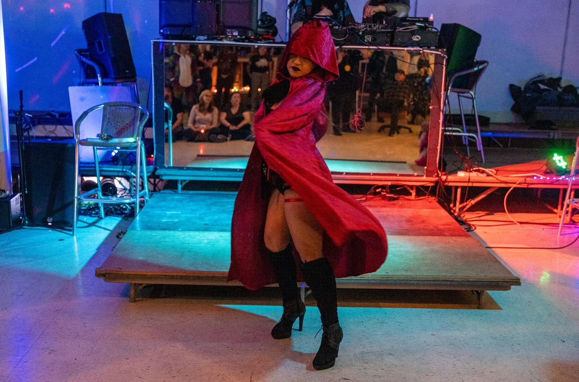 Woman in a red hood wearing black boots