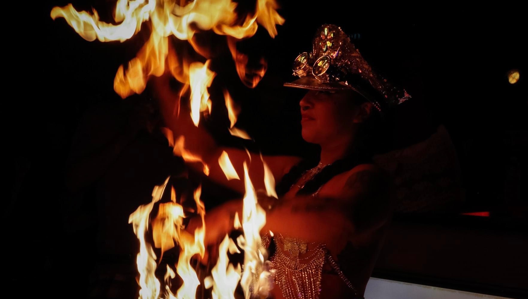 Woman posing with fire fans